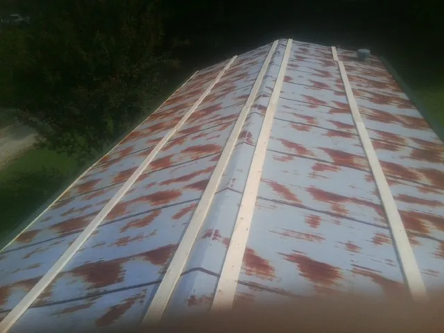 Rusted metal roof panels with new wood purlins before replacement — Storm Damage Roof Repair in Kings Bay by Roofing Brothers